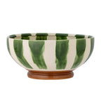 Ceramic bowl with green and white striped pattern on a white background
