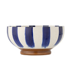 Ceramic bowl with blue and white striped design on a white background