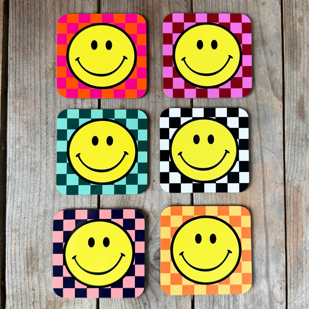 Smiley Coasters on a Checkerboard background. Designed by Love Frankie
