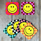 Smiley Coasters on a Checkerboard background. Designed by Love Frankie