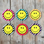 Smiley Coasters on a Striped background. Designed by Love Frankie